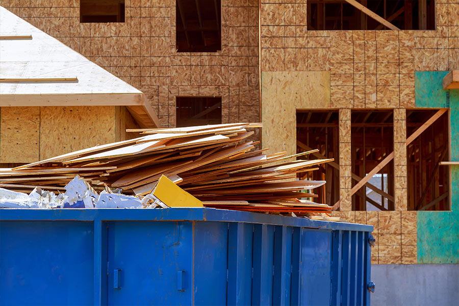 dumpster with trash in front of construction area garner nc (1)